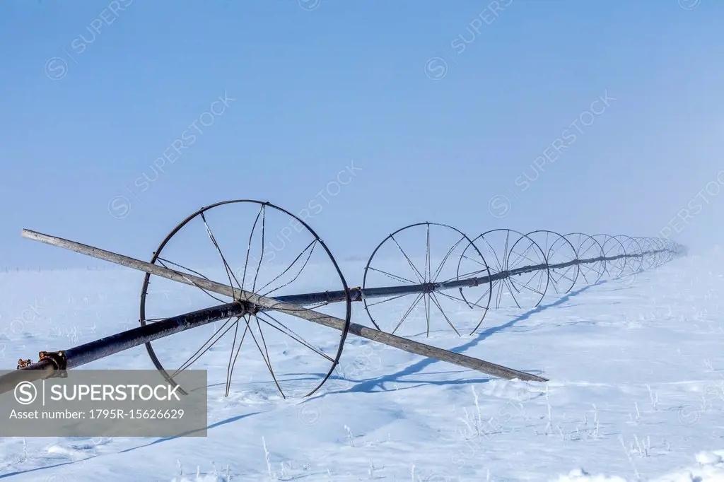 Sprinkler system on field during winter
