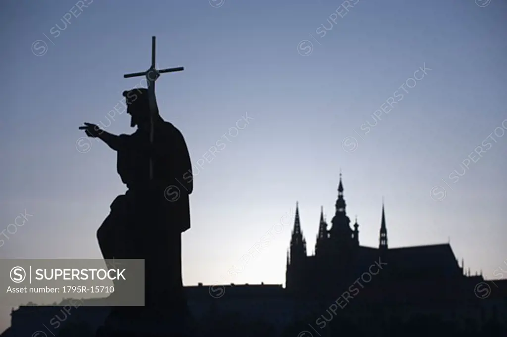 Silhouetted statue and cathedral