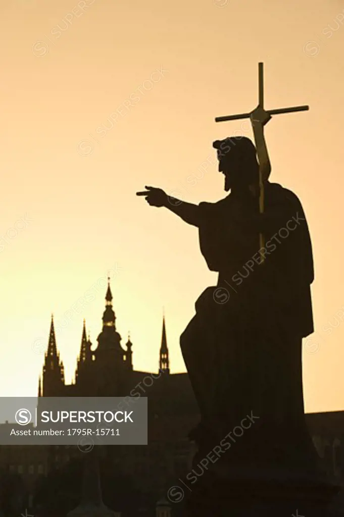Silhouetted statue and cathedral