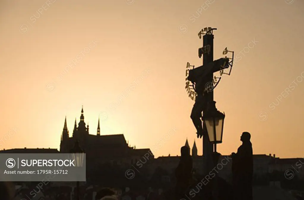 Silhouetted crucifix and cathedral