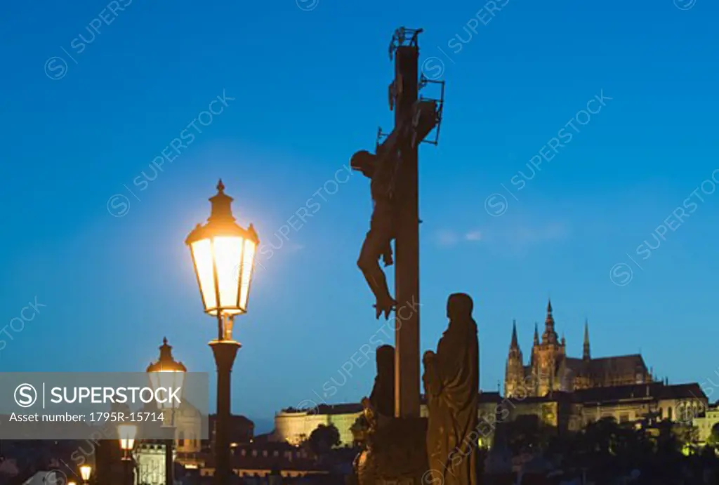 Night view of crucifix and cathedral