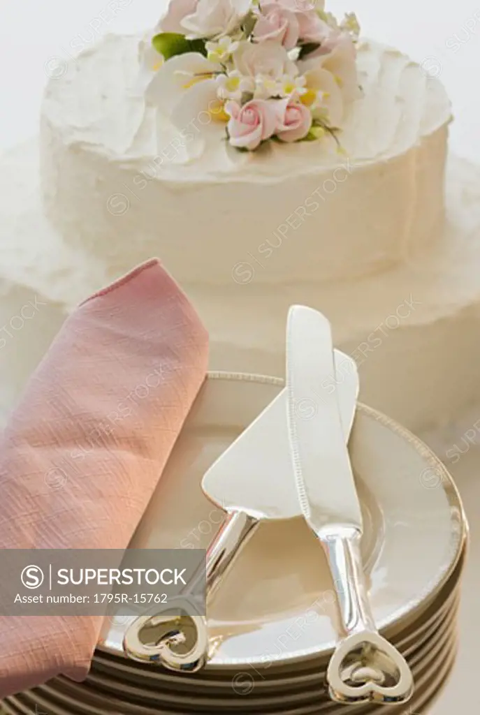 Wedding cake and stack of plates