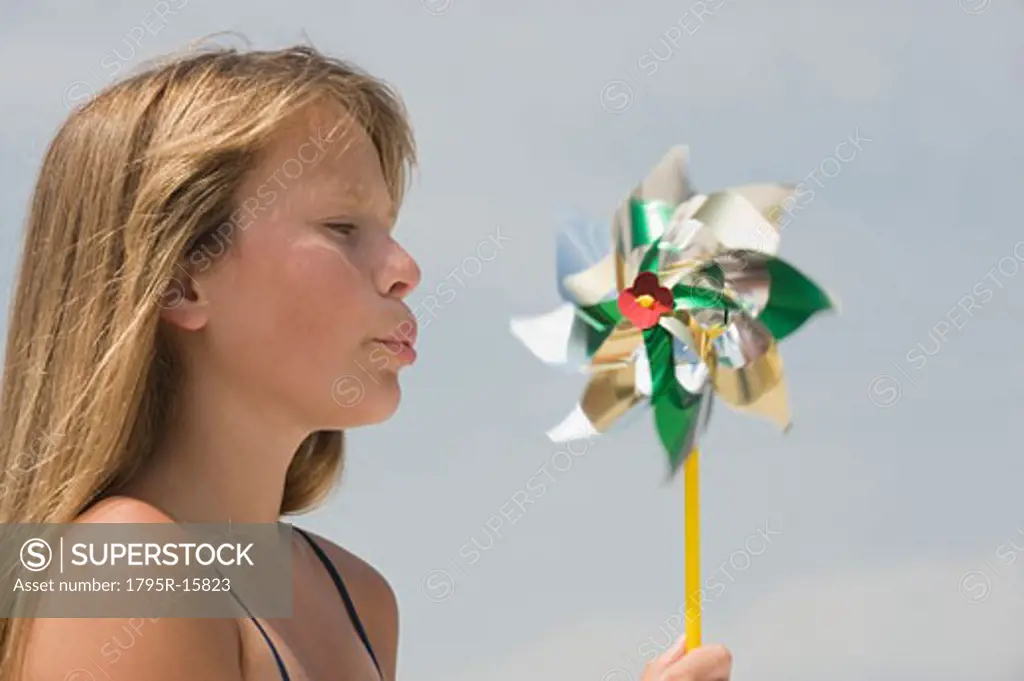 Girl blowing on pinwheel
