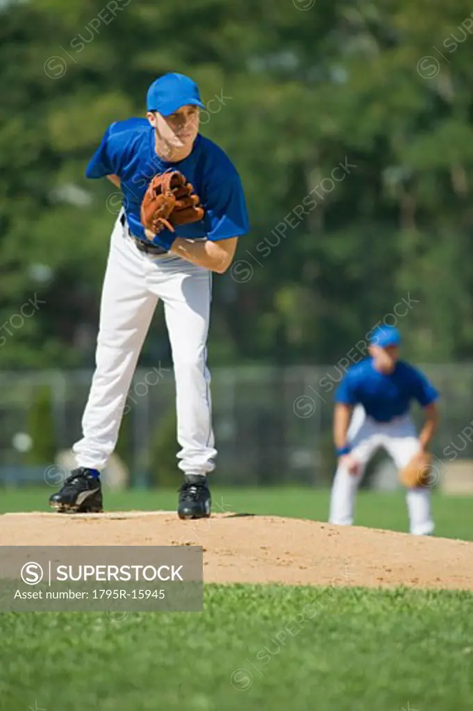Baseball pitcher preparing to pitch ball