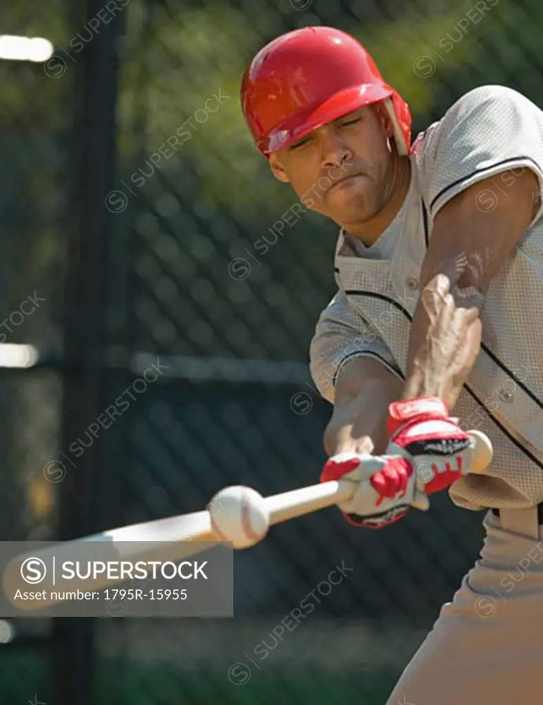 Baseball batter hitting ball