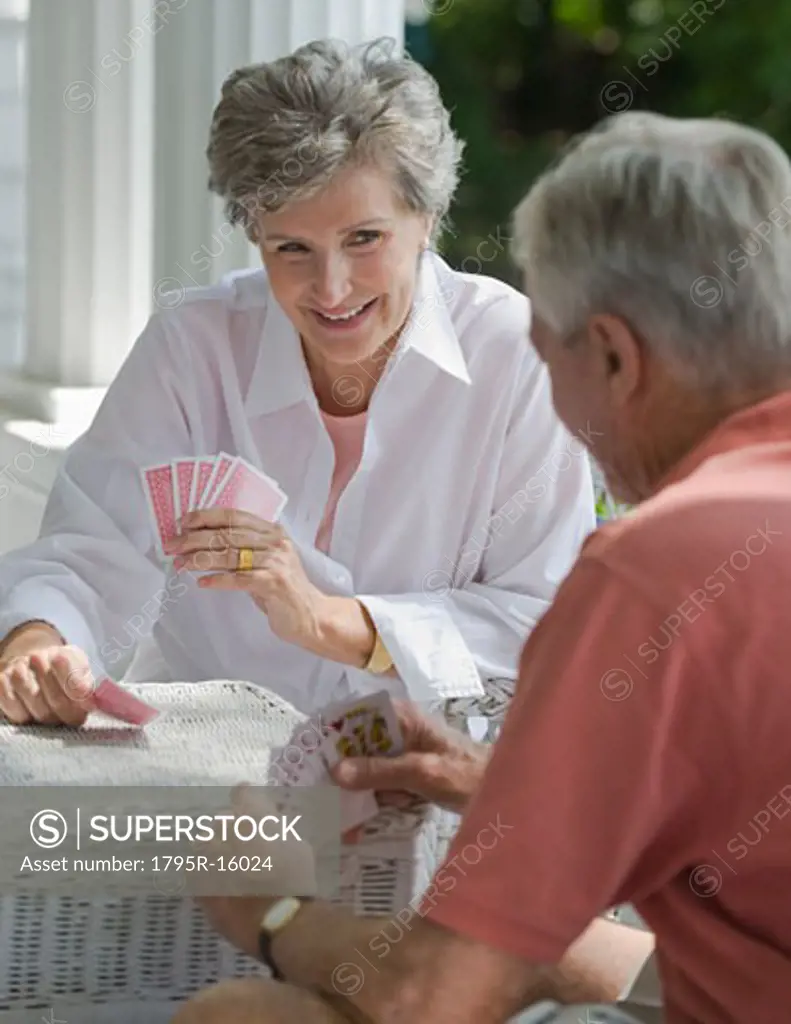 Senior couple playing card game on porch