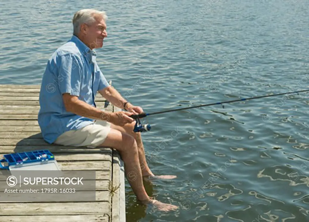 Senior man fishing off dock