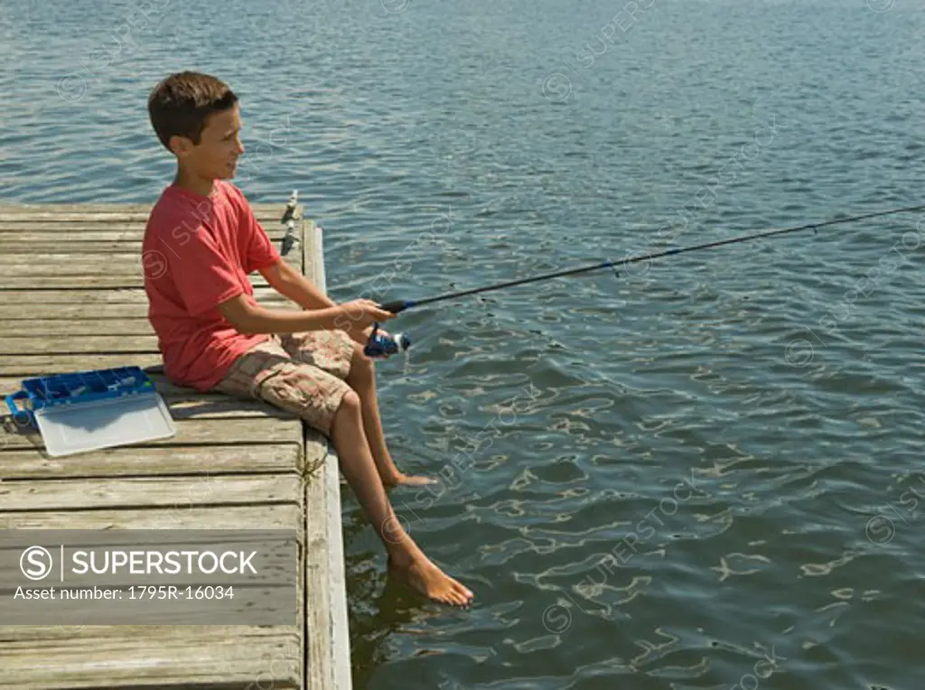 Boy fishing off dock