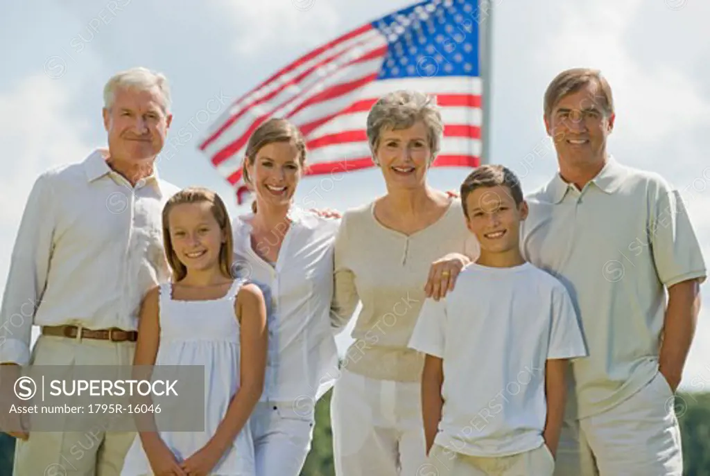 Multi-generational family posing in front of American flag