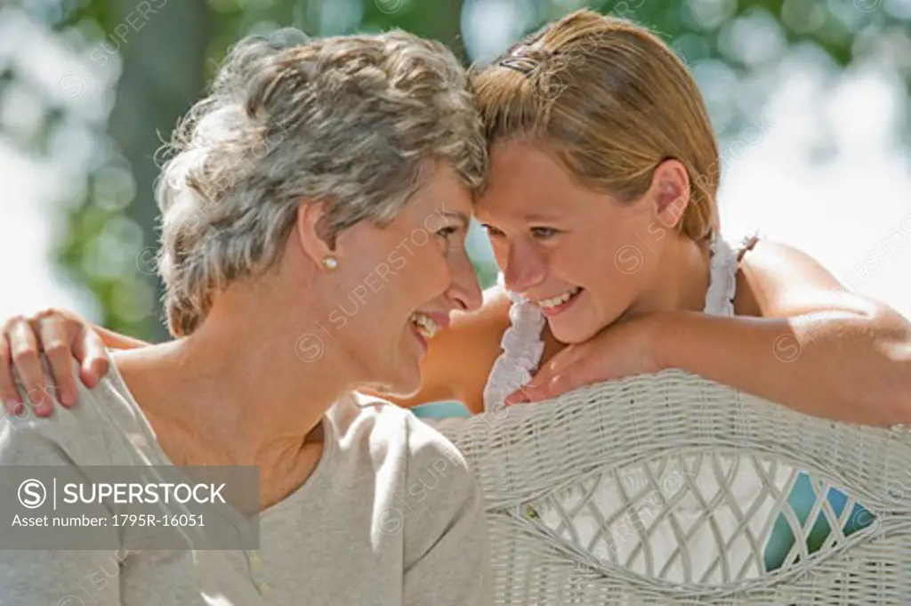 Grandmother and granddaughter smiling at each other