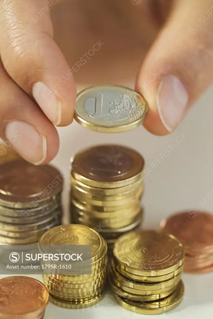 Man stacking Euro coins