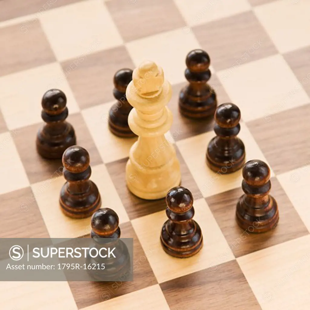 Pawns surrounding king on chessboard