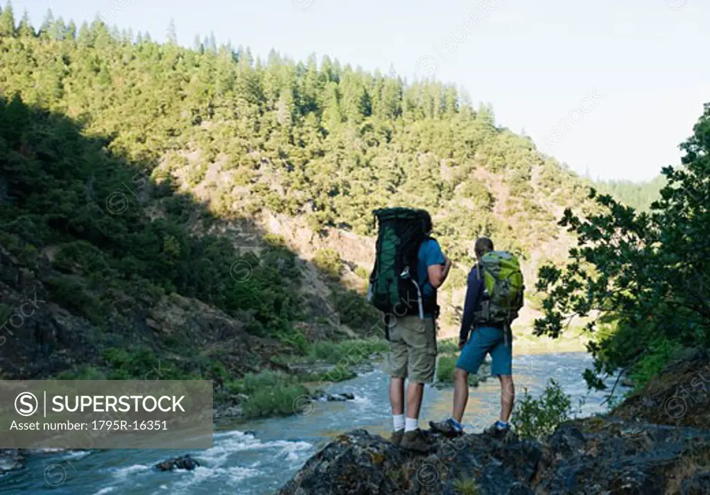 Hikers admiring view of river