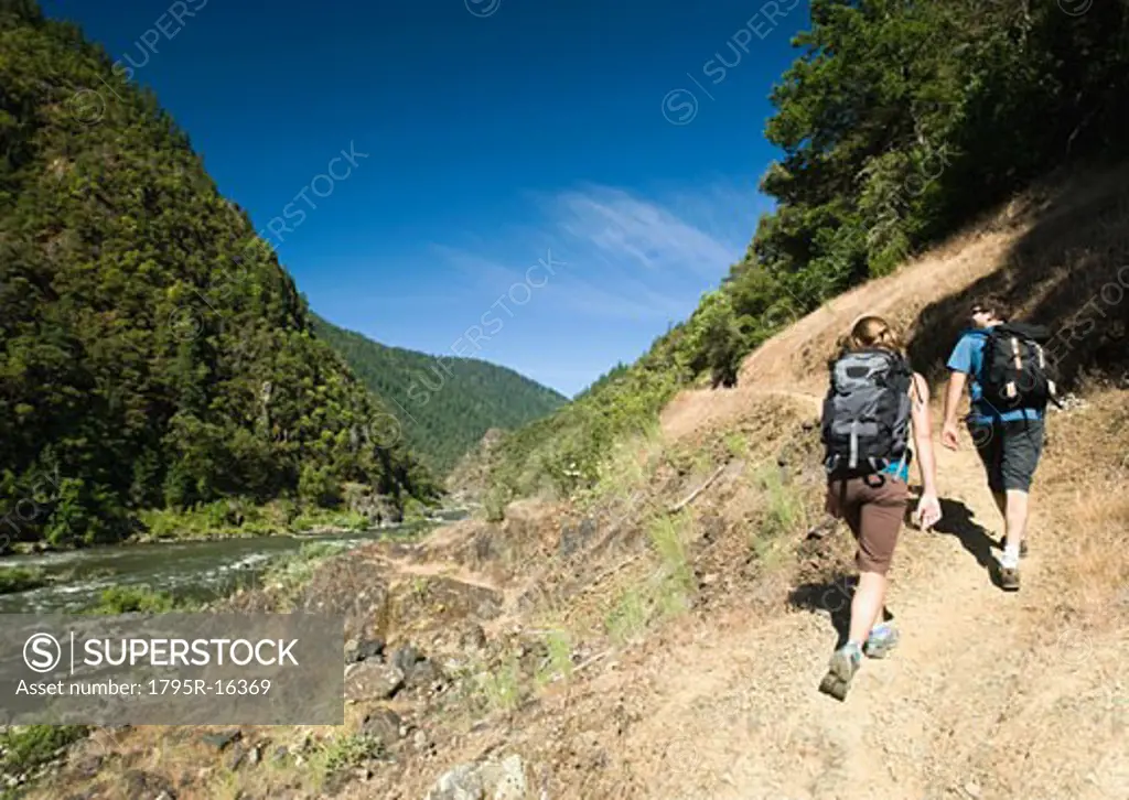 Hikers walking on riverside trail
