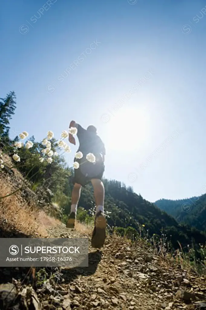 Man running on steep trail