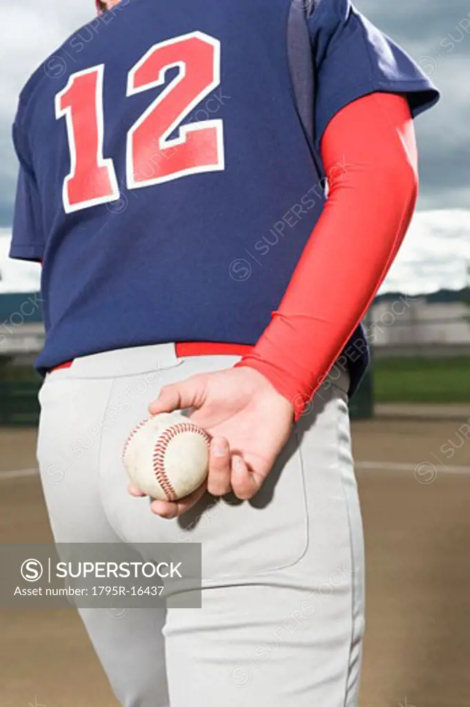Baseball pitcher getting ready to throw ball