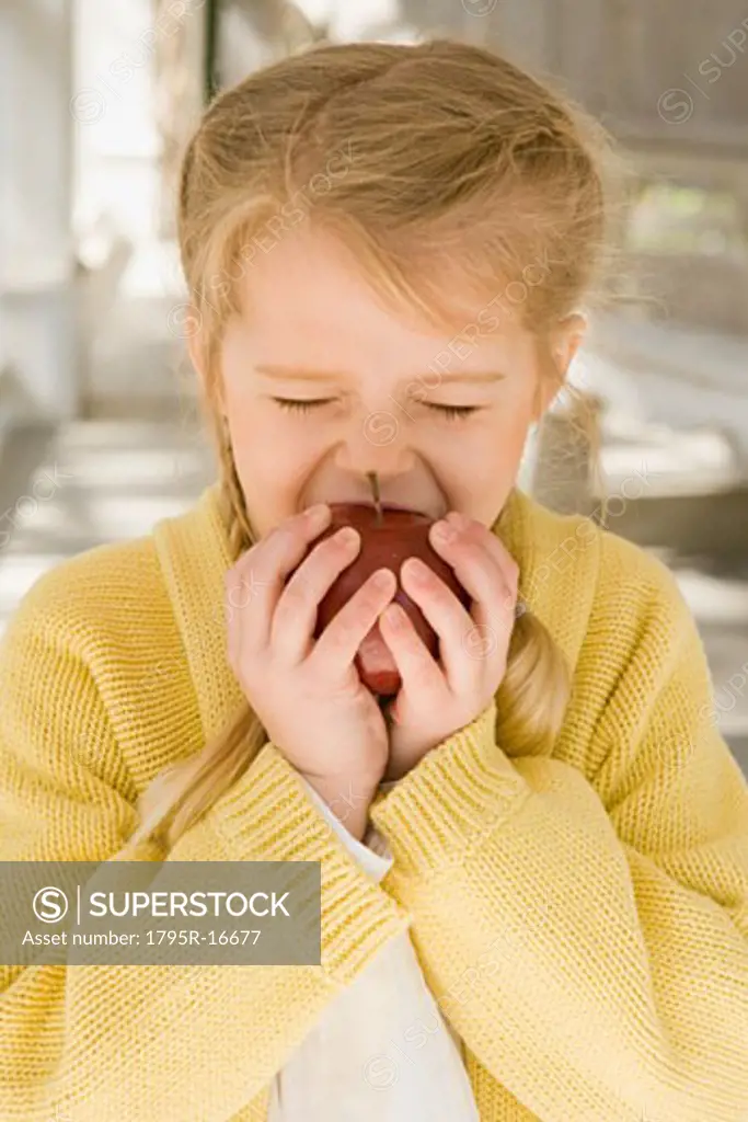 Girl eating apple porch