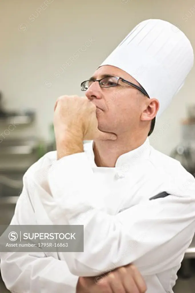 Chef in uniform concentrating