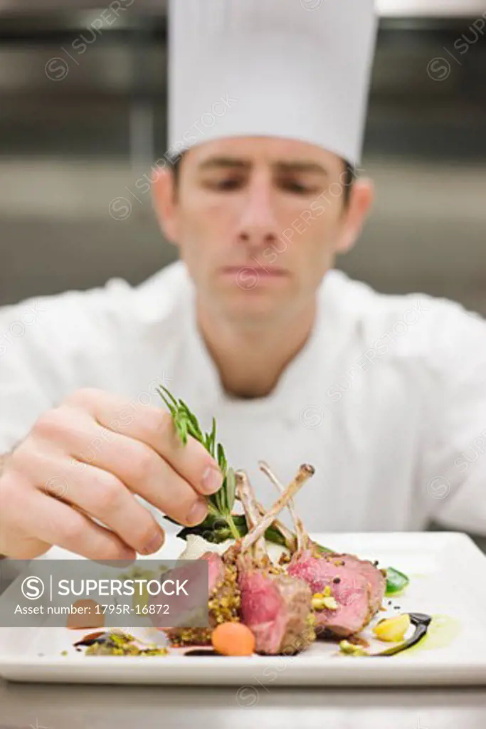 Chef arranging plate of food