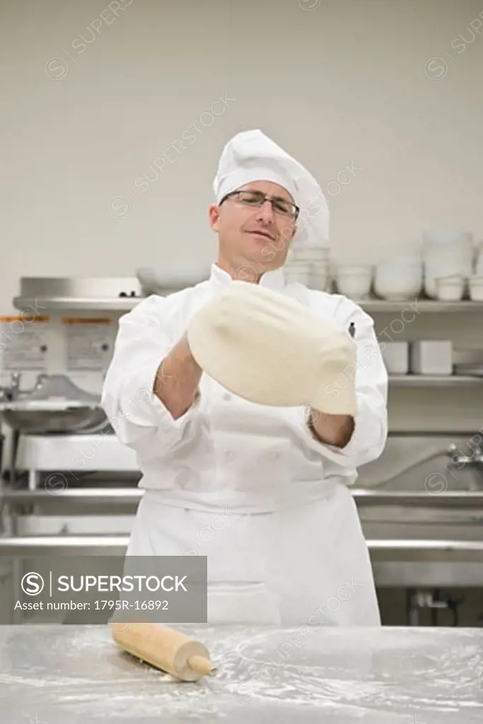 Chef stretching pizza dough