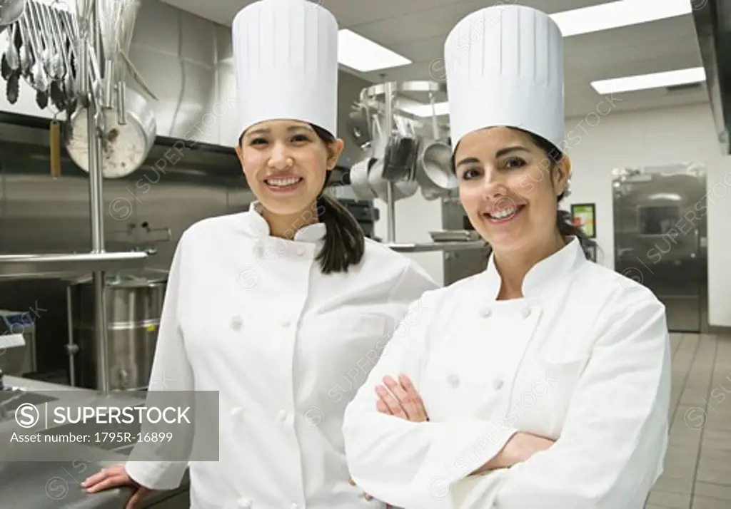 Female chefs posing in kitchen