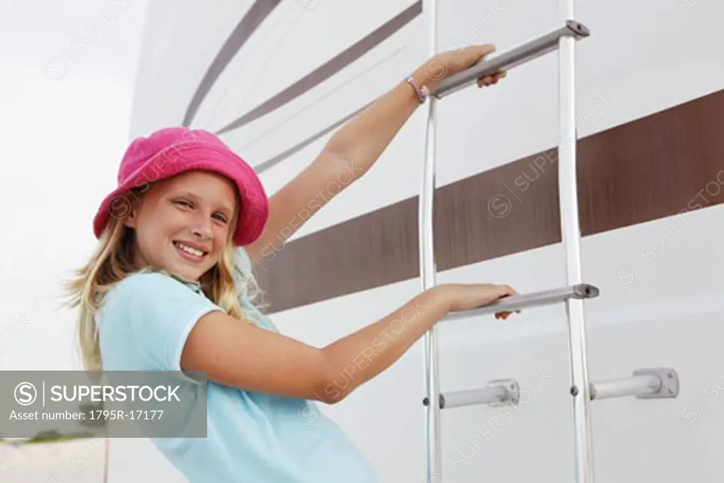 Girl climbing on motor home ladder