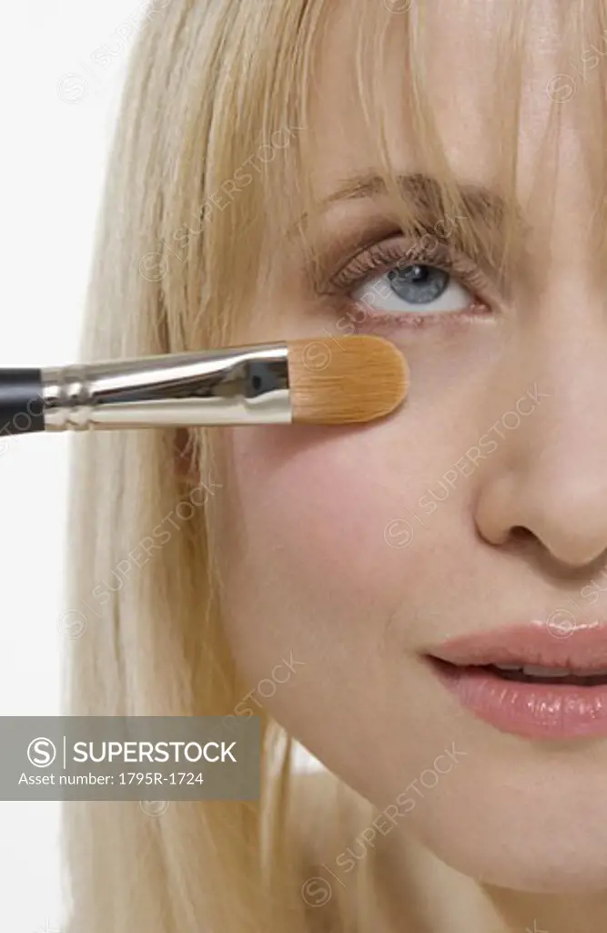 Closeup of cosmetic brush on face