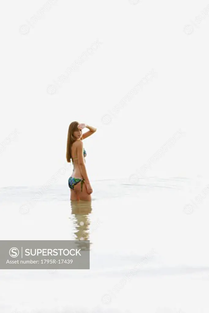 Teenage girl wading in ocean