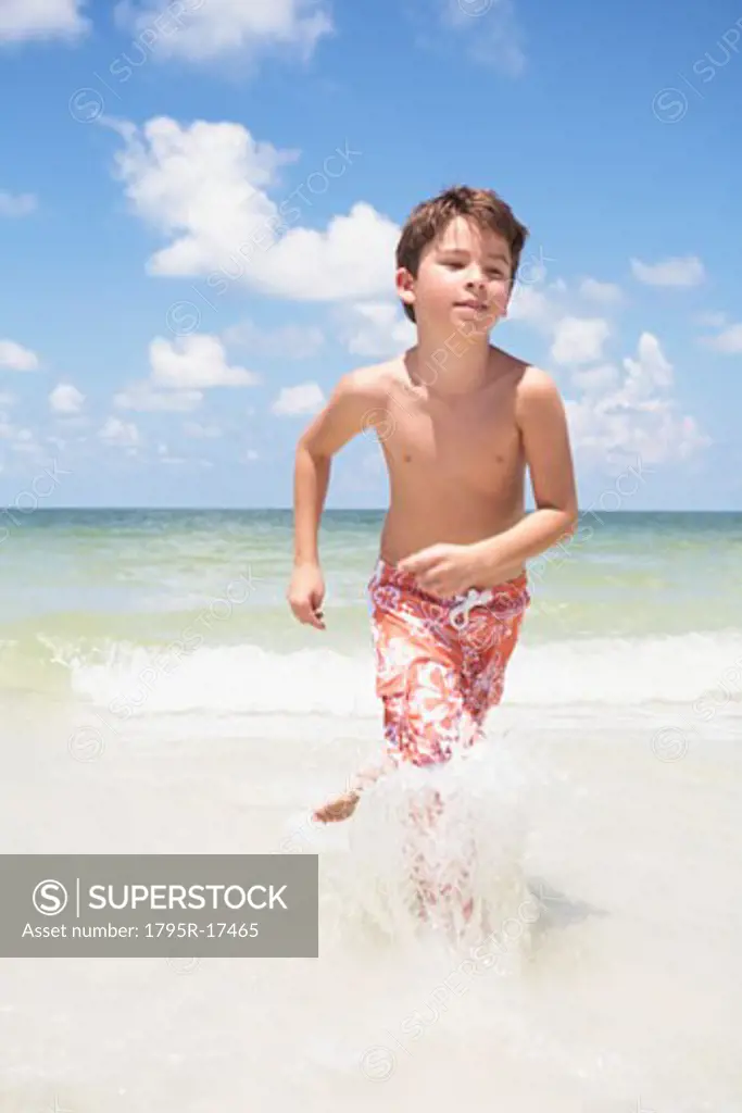 Boy running in ocean