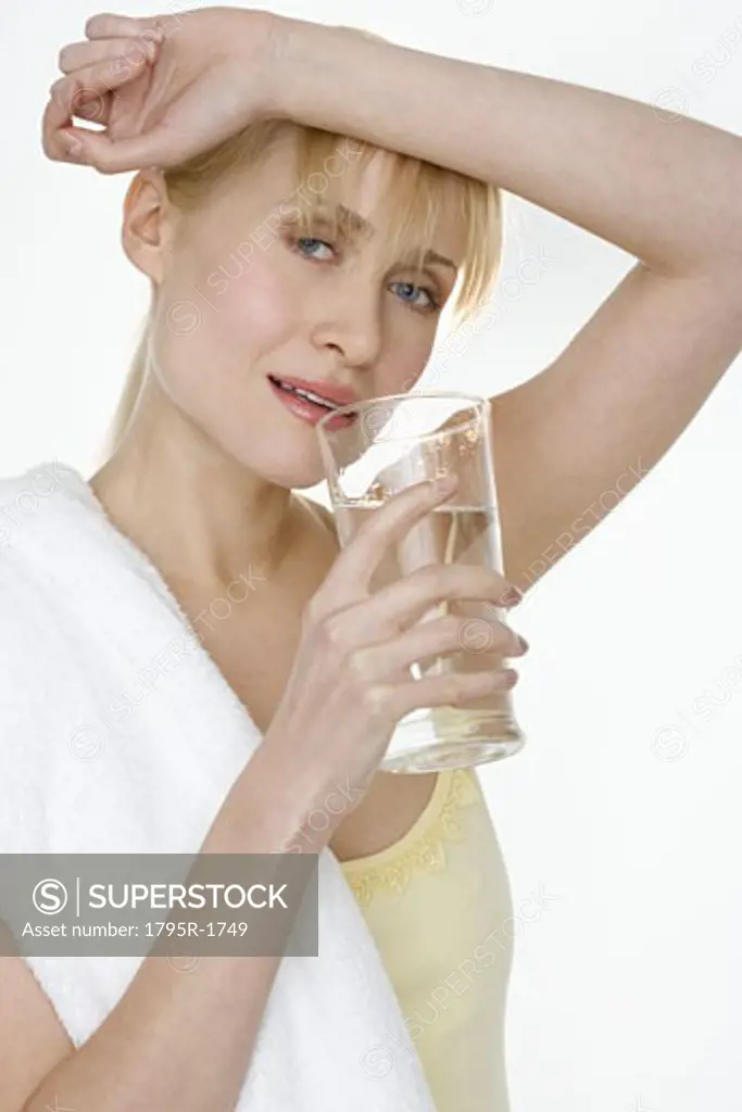 Woman with towel drinking water