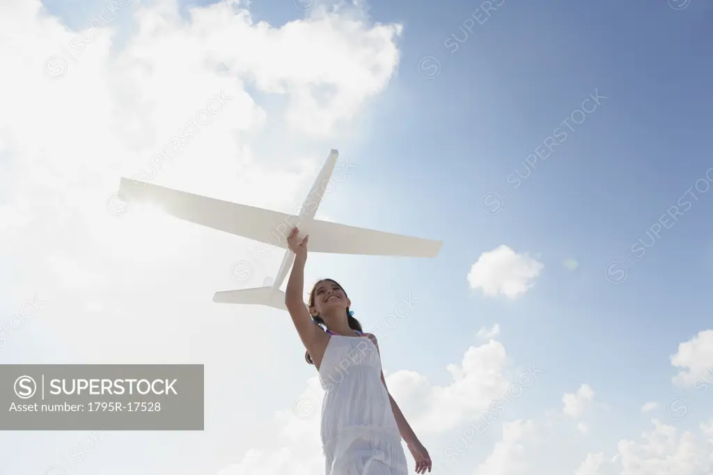 Girl flying model airplane