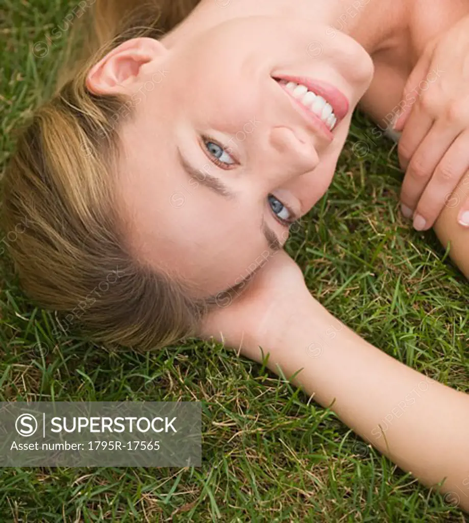 Close-up of woman laying in grass