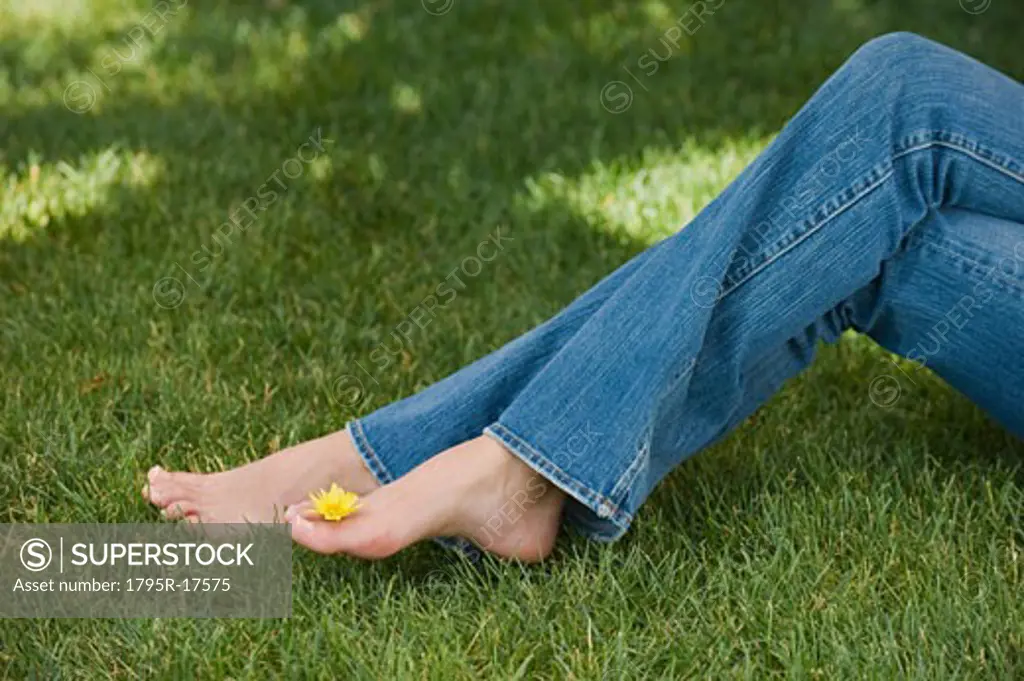 Woman balancing flower on toes