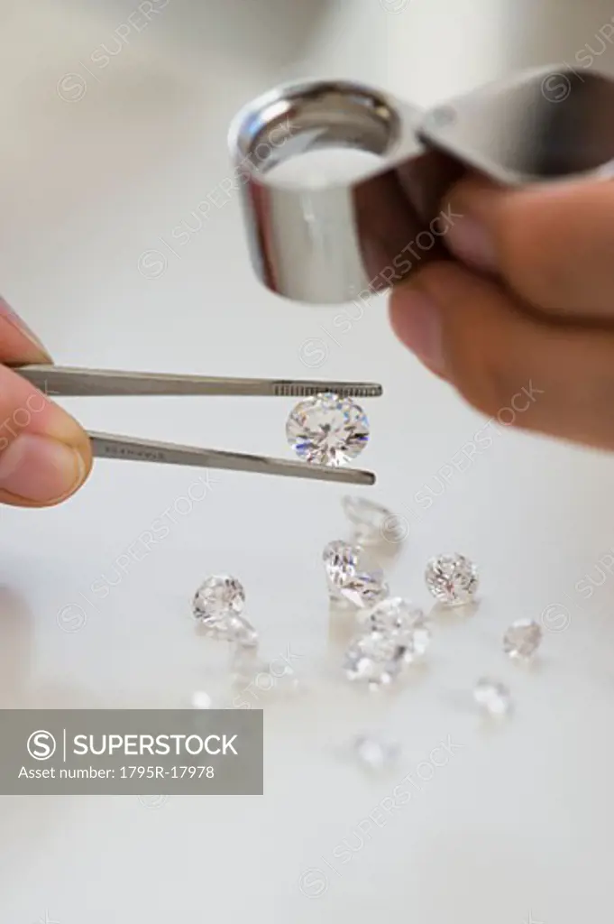Gemologist inspecting diamonds using loupe