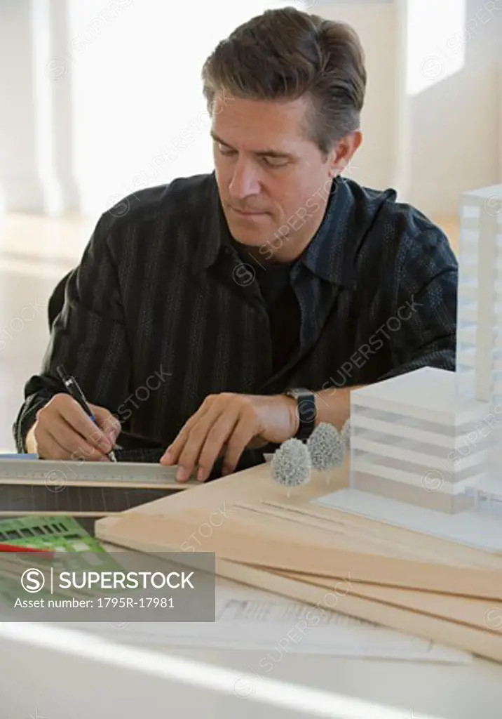 Architect working on building model