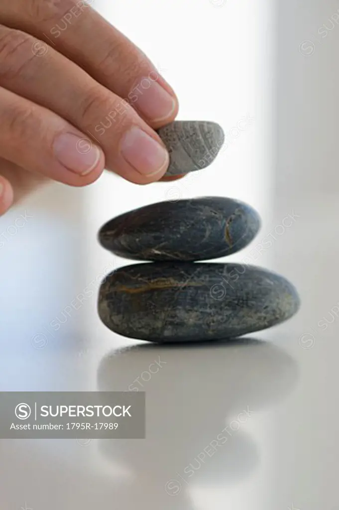 Hand stacking stones