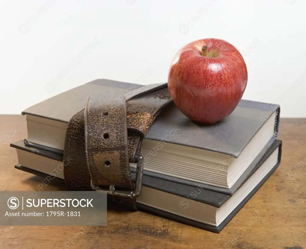 Schoolbooks with red apple