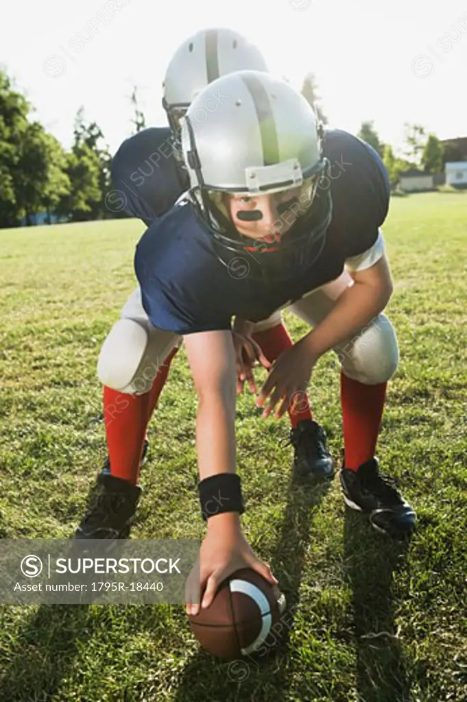 Football center preparing to snap football