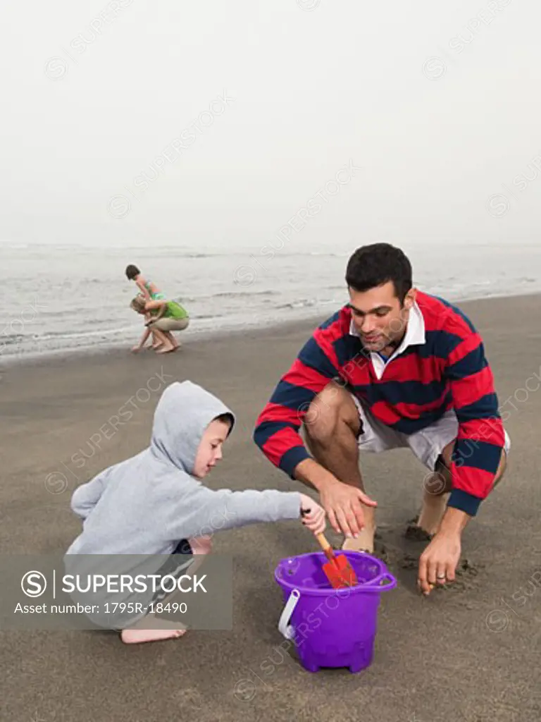 Family looking for shells on beach