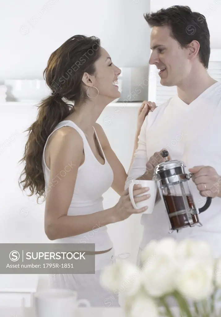 Laughing young couple with coffee
