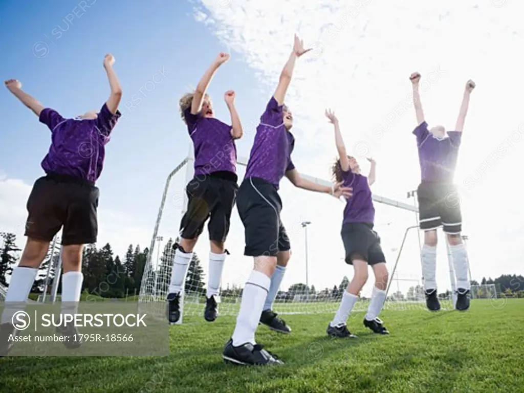 Boys soccer team celebrating on field