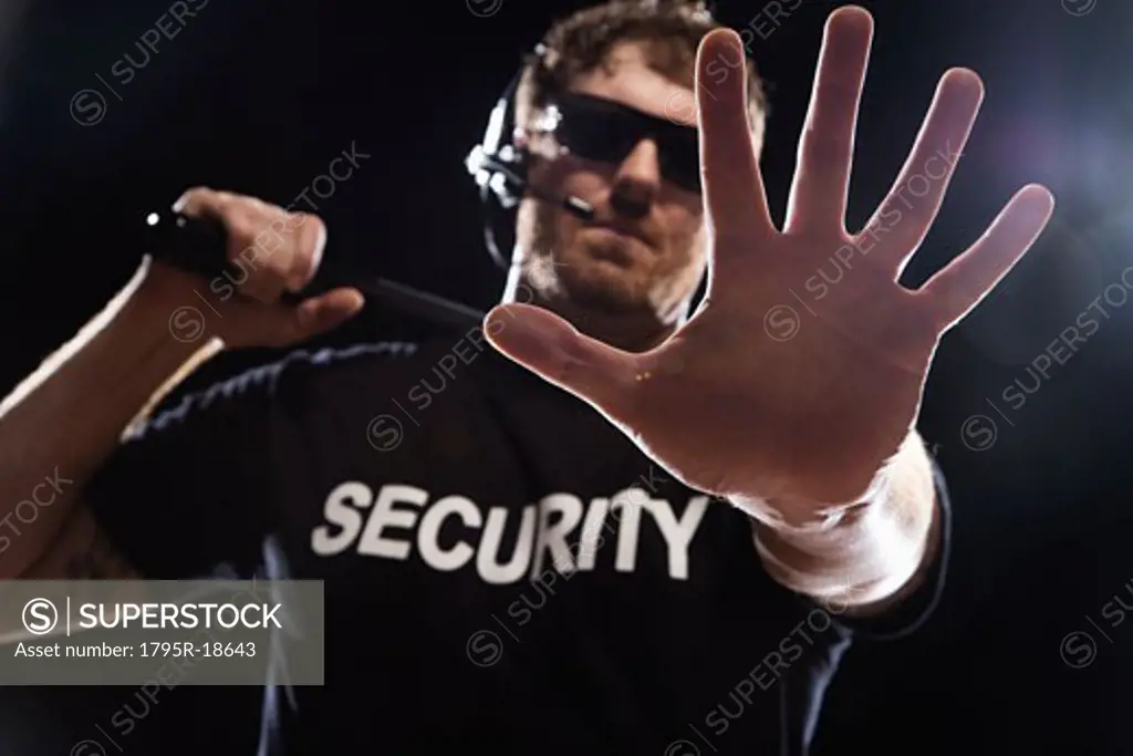 Security guard extending hand