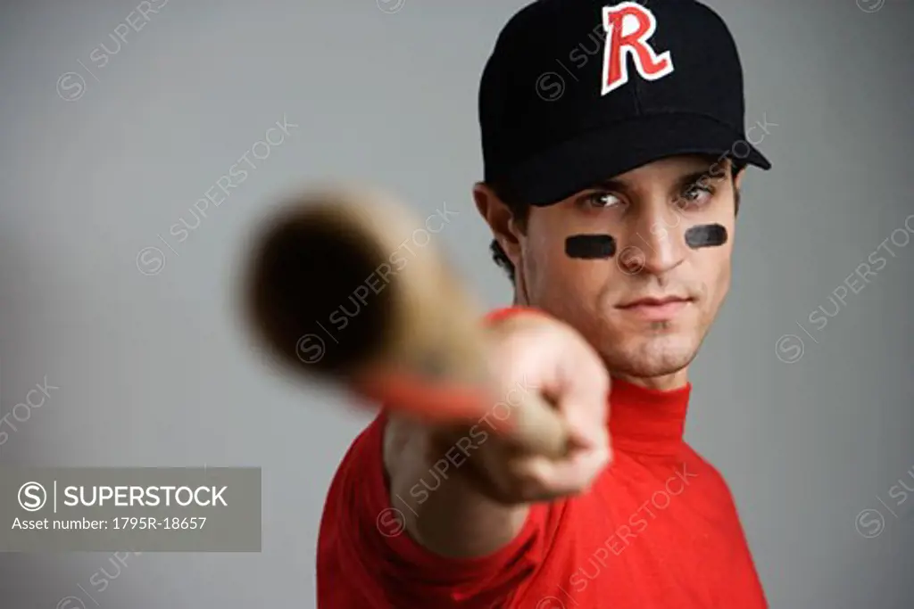 Close-up of baseball player pointing bat