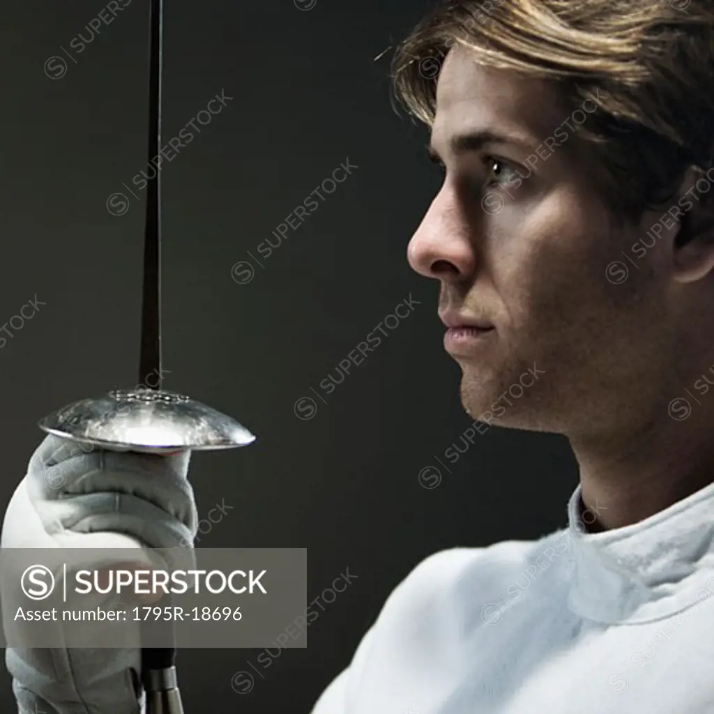 Close-up of man holding fencing foil