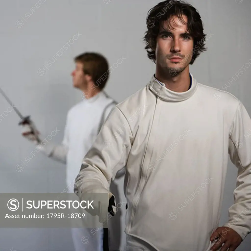 Portrait of fencers holding fencing foils