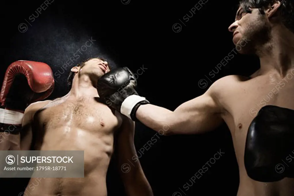 Boxer punching opponent in jaw