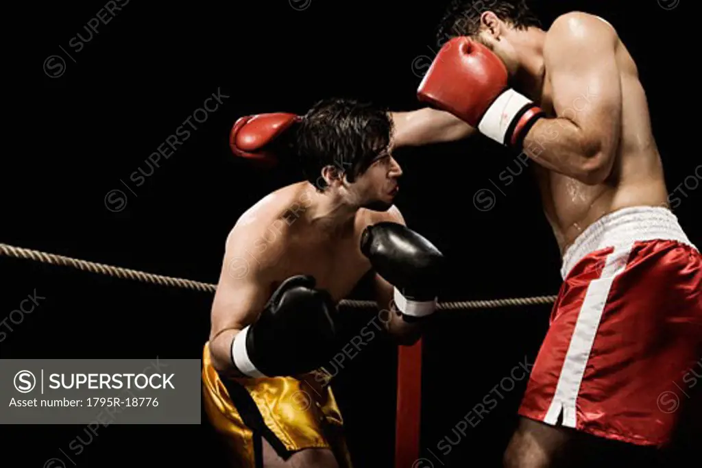 Boxers fighting in boxing ring