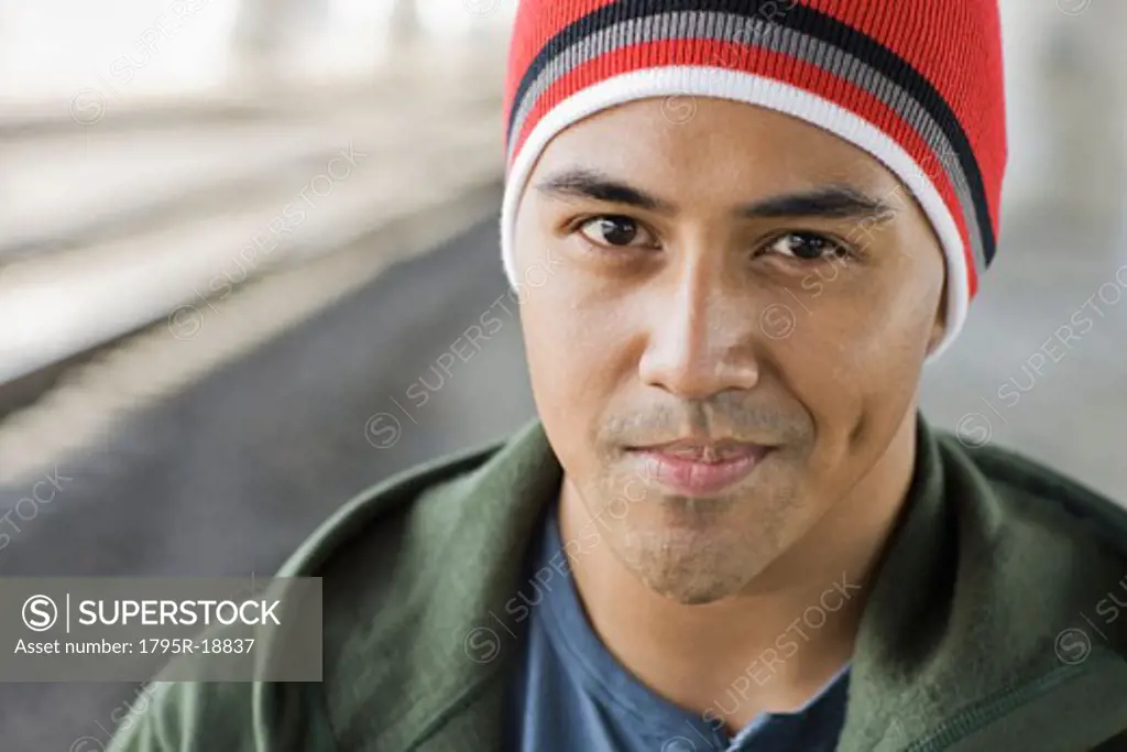 Portrait of young man with stocking cap smiling