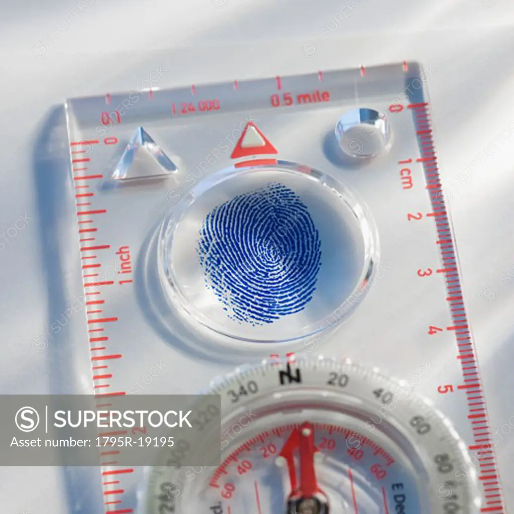 Close-up of compass and fingerprint