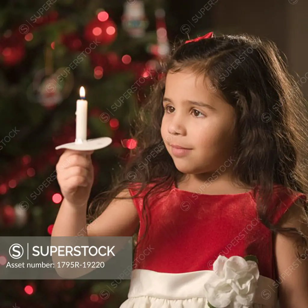 Girl holding Christmas candle
